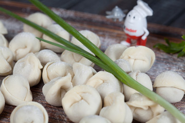 Fototapeta na wymiar real, delicious, Russian dumplings on the table, with fresh herbs and spices, for cooking design. 