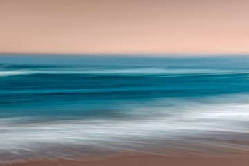Abstract ocean seascape with blurred panning motion in blue and pink colors
