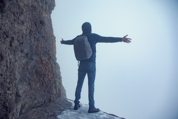 Fototapeta na wymiar traveler man in rock with fog