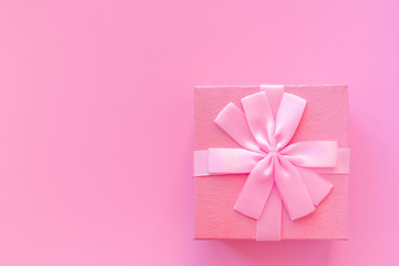 Cute pink gift box on pink background.