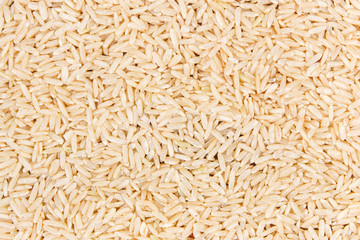 Heap of brown rice as background, healthy, gluten free nutrition concept, copy space for text