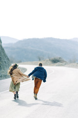 A beautiful couple travels to the sights of Georgia. Lovestory in nature with a lake and a field.