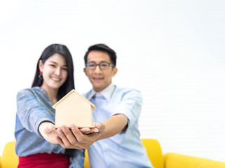 Fototapeta premium Young asian happiness couple love family male and female talking about house purchase and house owner discussing a choice with home plan, real estate and family house concept