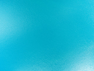 Fototapeta na wymiar Aerial view of a Crystal clear sea water texture. View from above Natural blue background. Turquoise ripple water reflection in tropical beach. Blue ocean wave. Summer sea. Drone. Top view