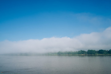 Fototapeta premium The sky, fog, and the river