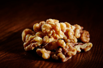 Walnuts on wooden table with dramatic lighting