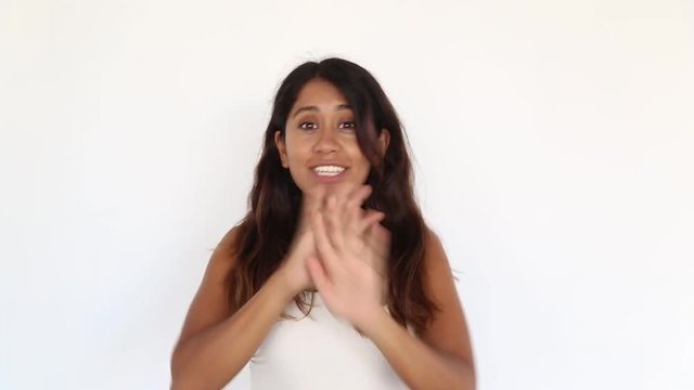 Portrait of young pretty mexican girl who is showing objection gesture with word no. Facial expression concept.