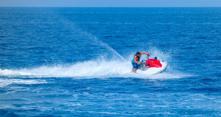 Man on jet ski jump on the wave