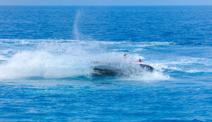 Obraz premium Man on jet ski jump on the wave