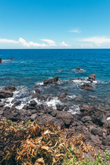 Fototapeta na wymiar Dream island. Wild tropical beach with rocks and contrast blue sky. Bali island.