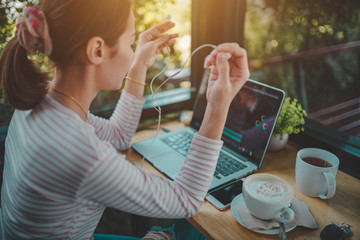  Young woman freelance use laptop editing video footage in the coffee shop this is lifestyle of content creator