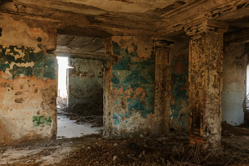 Mystical interior, ruins of an abandoned ruined building of house of culture, theater of USSR. Old destroyed walls, corridor with garbage and dirt. Destroyed molding, plaster ornaments, bas-relief