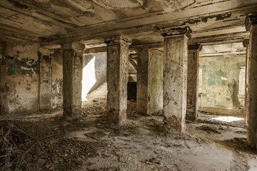 Fototapeta na wymiar Mystical interior, ruins of an abandoned ruined building of house of culture, theater of USSR. Old destroyed walls, corridor with garbage and dirt. Destroyed molding, plaster ornaments, bas-relief
