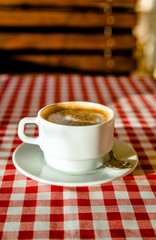 A Cup of cappuccino is on the table in the cafe 
