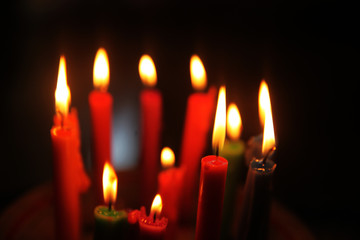 Colored candles burning in the dark