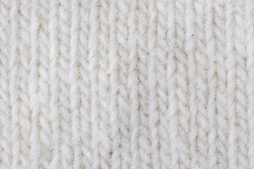 Light knitted texture closeup, visible yarn and fiber. The image is suitable as a background for various tasks.