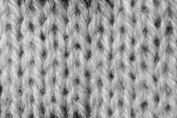 Light knitted texture closeup, visible yarn and fiber. The image is suitable as a background for various tasks.