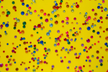 Crystals. Crystal strasses on a abstract  blurred  yellow background. Beautiful shiny sparkling silver rhinestones. Jewelry, rhinestones, shiny stones.