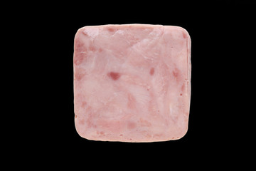 Piece of sliced pork ham isolated on black background. Top view.