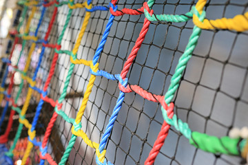 Colorful Rope net tied for climb. Indoors playground.