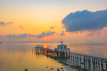 aerial view sunrise at pier of Phayam temple one landmark of Phayam island. Phayam temple is on Hin Kao gulf. .The temple is close to the shipping port. in the end of Phayam temple pier have memorial
