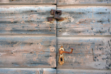 Rusty lock on old wooden doorsc, close up