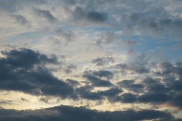 Obraz premium Beautiful yellow sunset with black dramatic clouds on horizon