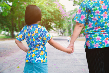 Mom walked in hand in the park.