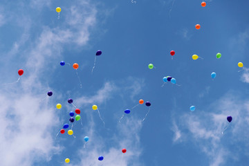 Balloons flying to the blue sky