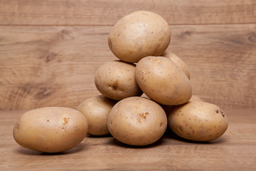 Fototapeta premium Potatoes on the wooden table.