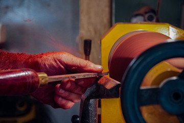 Carpenter working on a lathe close-up. Wood processing
