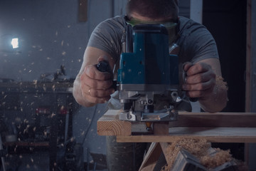 Milling. Carpenter working for the machine.