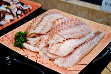 Sashimi buffet, fresh raw fish on plate