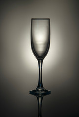 Silhouette of a champagne glass on a gray-brown background.
