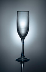 Silhouette of a champagne glass on a gray-blue background.