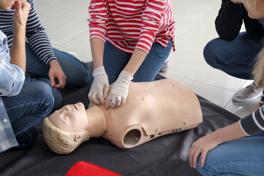 People learning to perform CPR at first aid training course