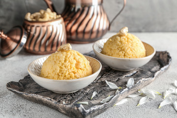 Bowls with traditional Indian food pongal on table