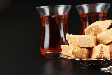 Bowl with pieces of turkish delight lokum and black tea