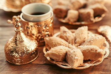 Turkish sweets with coffee on a wooden table