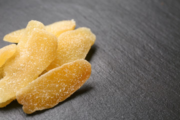 Tasty dried ginger on dark background