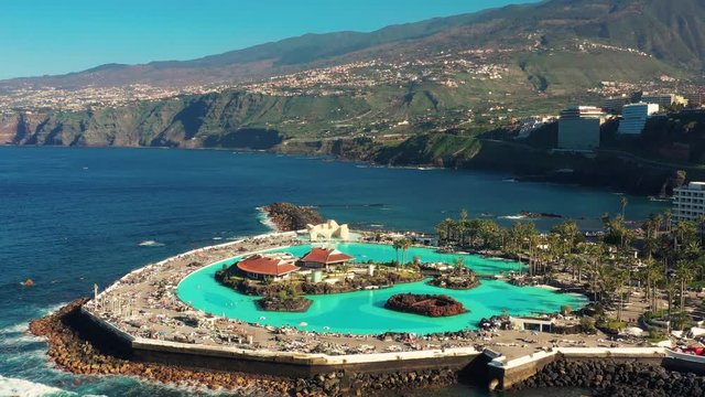 Drone flying over a Pool near the Ocean, beautiful Vacation concept.