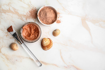 Cosmetic clay with brush on light table