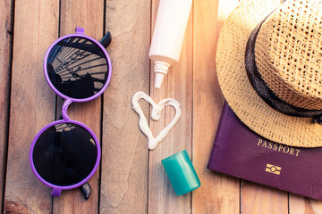 Fototapeta na wymiar passport with hat and sun block cream for travel adventure
