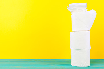 Toilet paper stacks  on bright yellow background