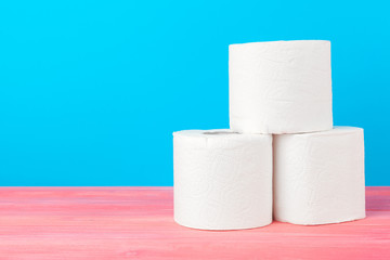 Toilet paper stack on bright blue background