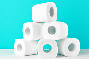 Toilet paper rolls on turquoise bright background
