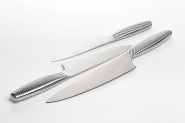 Fototapeta premium Set of steel kitchen knives on white background