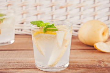 Pear Lemonade or mojito cocktail with pear, lemon and mint, cold refreshing drink or beverage