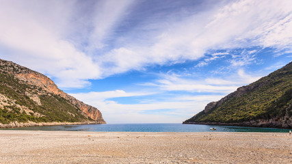 Fototapeta na wymiar Beautiful Greek sand beach with cliffs