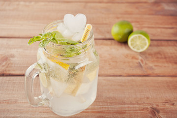 Lemonade or mojito cocktail with lemon and mint, cold refreshing drink or beverage with ice